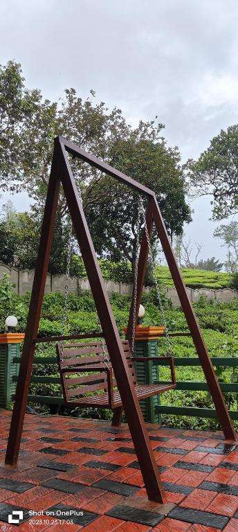 Metal swing overlooking tea estate hills